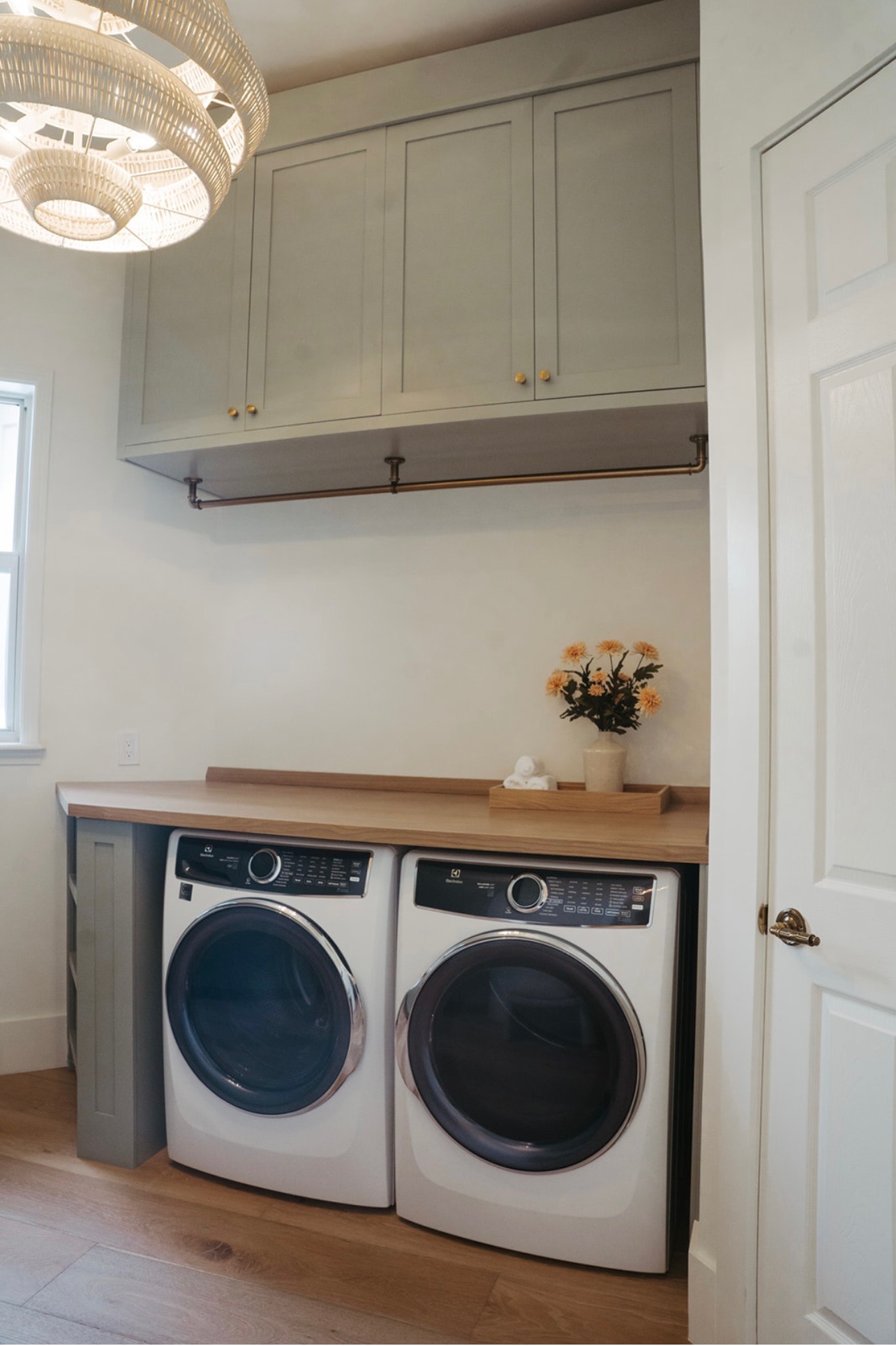 Custom Upper Laundry Room Cabinets with industrial hanging bar